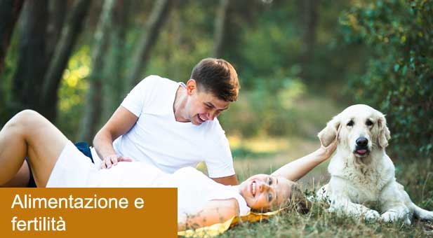 pregnant-woman-with-husband-lying-in-the-park-PUCUX3U